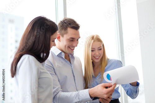 business team looking at clipboard photo