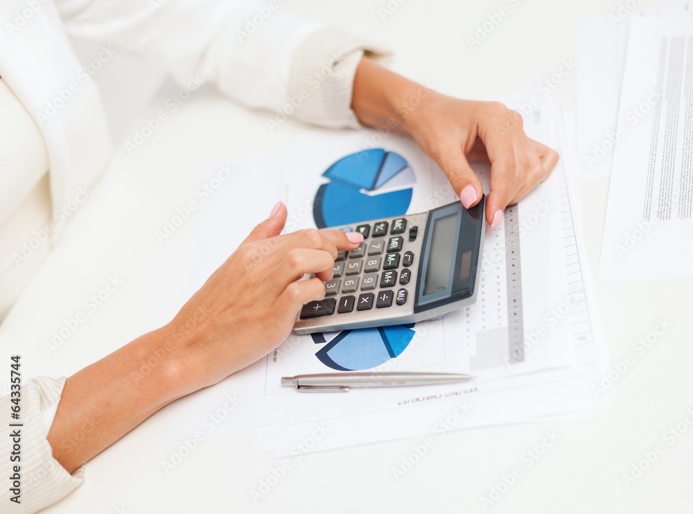 businesswoman working with calculator in office businesswoman working with calculator in office