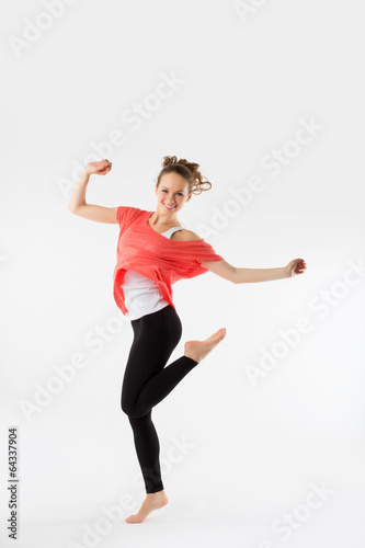 Young casual woman, student jumping. Isolated on grey.