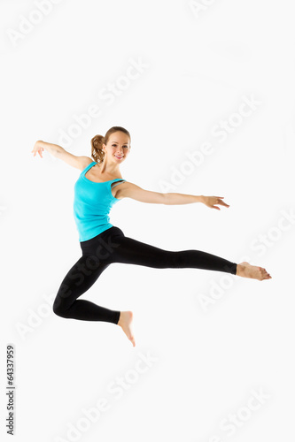 young and beautiful woman dancer posing on studio background
