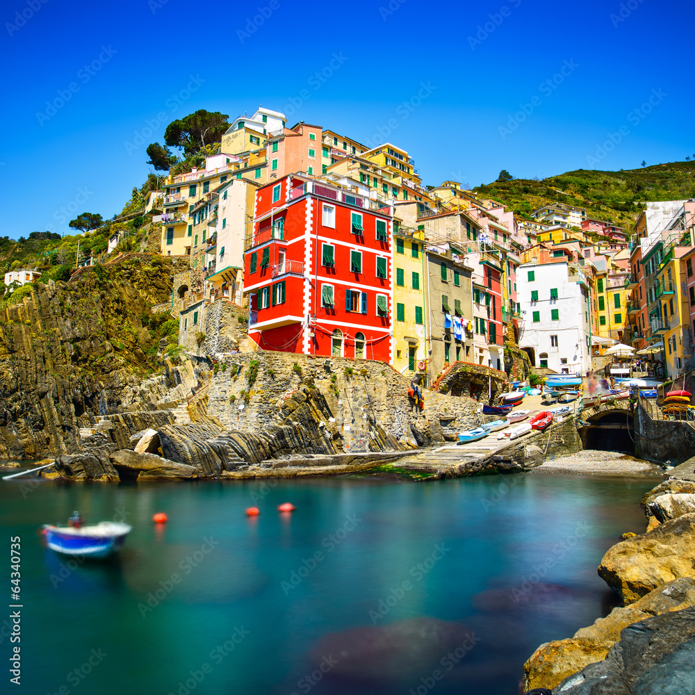 Riomaggiore village, rocks and sea at sunset. Cinque Terre, Ligu