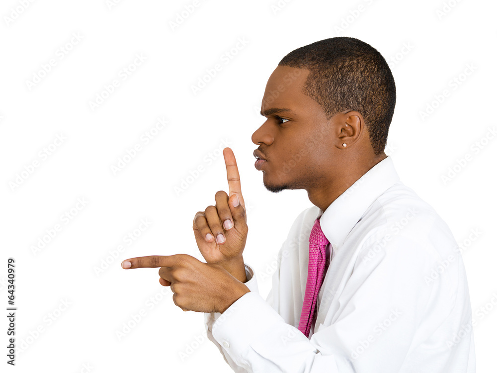Side profile young man with finger on lips asking silence Stock Photo