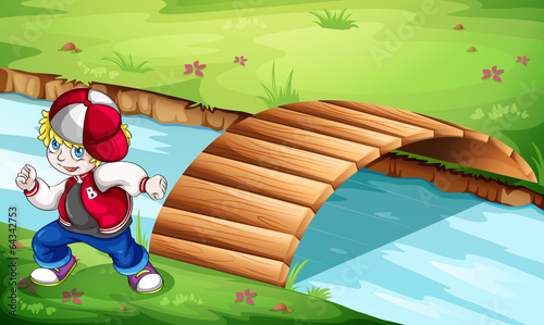 A hiphop dancer dancing near the wooden bridge