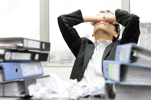 Thoughtful or stressful businessman at work