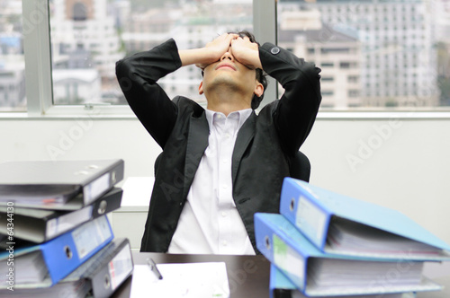 Thoughtful or stressful businessman at work
