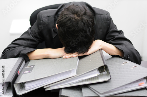 Thoughtful or stressful businessman at work