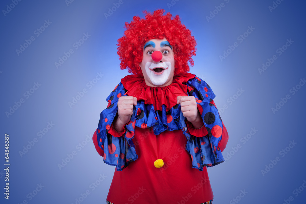 Happy clown in red costume on blue background