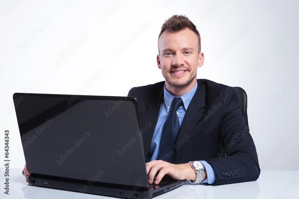 business man at laptop looks at you business man at laptop looks at you