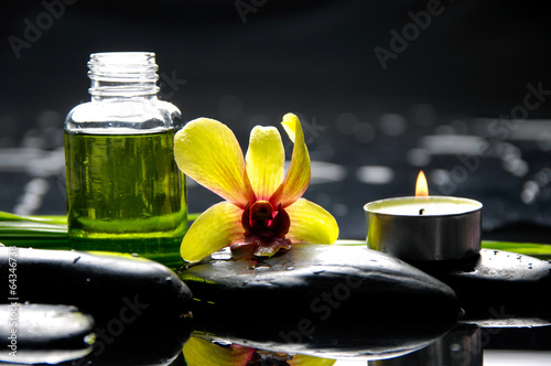 orchid with pebbles and massage oil  leaf  candle on wet
