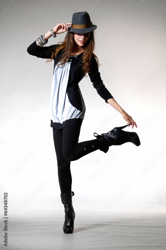Full length young girl in fashion dress with hat posing Full length young girl in fashion dress with hat posing