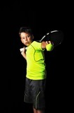 Portrait of handsome boy with tennis equipment