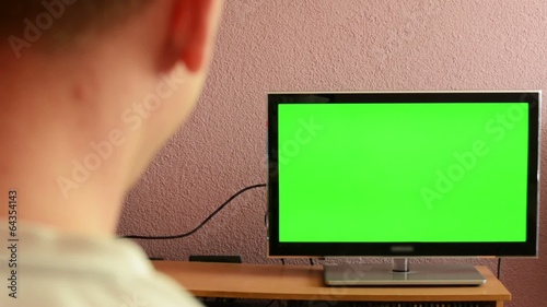 Man watches TV(television) - green screen - man laughs photo