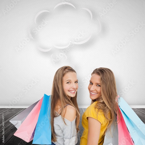 Composite image of two young women with shopping bags with speec photo