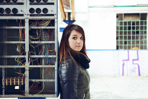 Young woman posing in industry abandoned