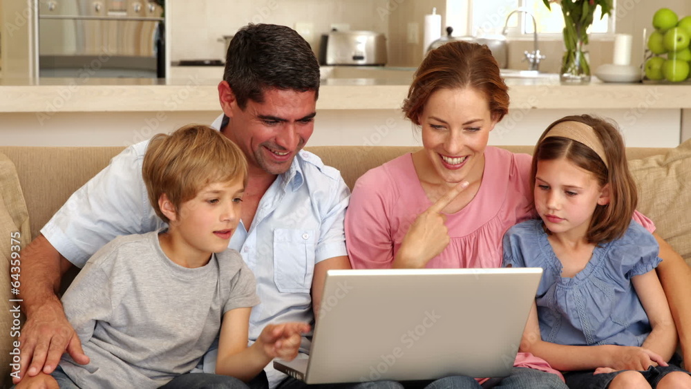 Happy family sitting on the sofa using laptop Happy family sitting on the sofa using laptop