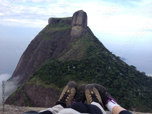 Sneackers on peak of mountain in clouds, Rio de Janeiro photo