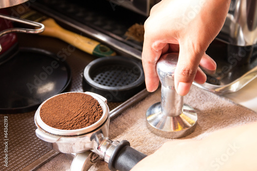 Barista Tamping Espresso Grounds