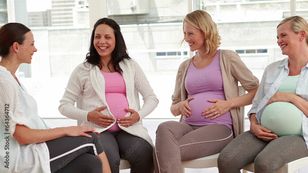 Pregnant women talking together at antenatal class Pregnant women talking together at antenatal class