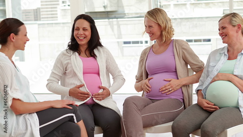 Pregnant women talking together at antenatal class photo