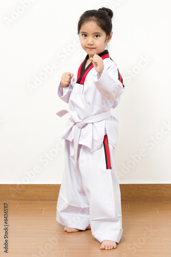 Little asian taekwondo child in fighting action