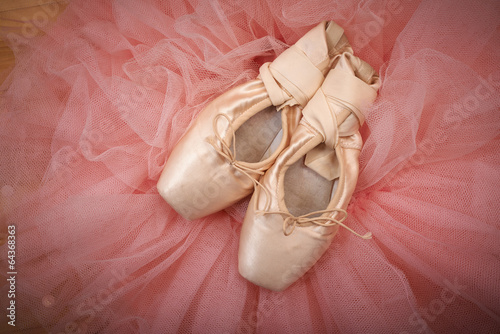 pair of ballet shoes pointes on wooden floor