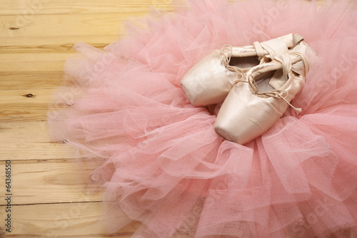 pair of ballet shoes pointes on wooden floor