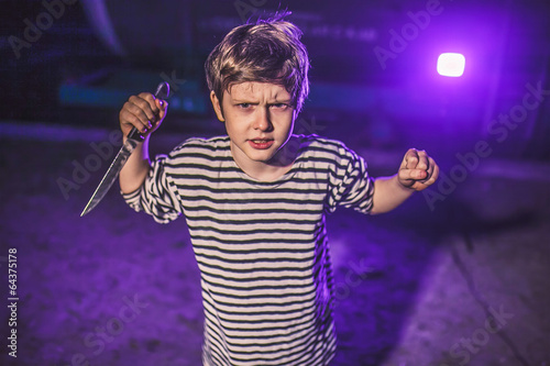 Teenage boy with knife brandishing threat of night attacks priso photo
