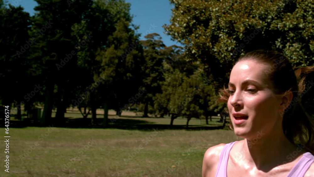 Fit woman sprinting past the camera Fit woman sprinting past the camera