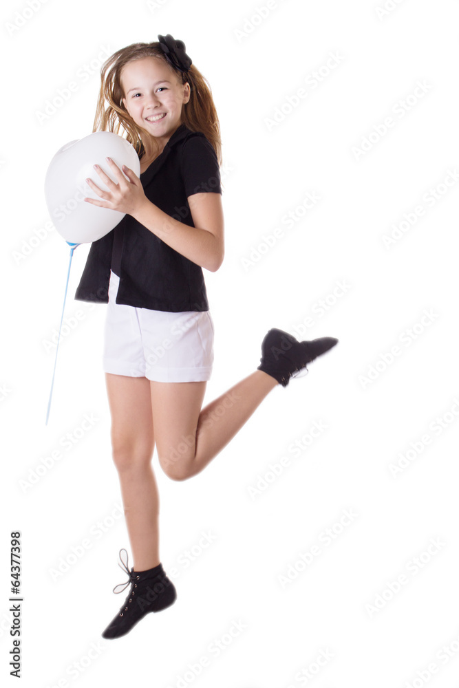 Happy girl jumping with heart-shaped balloon