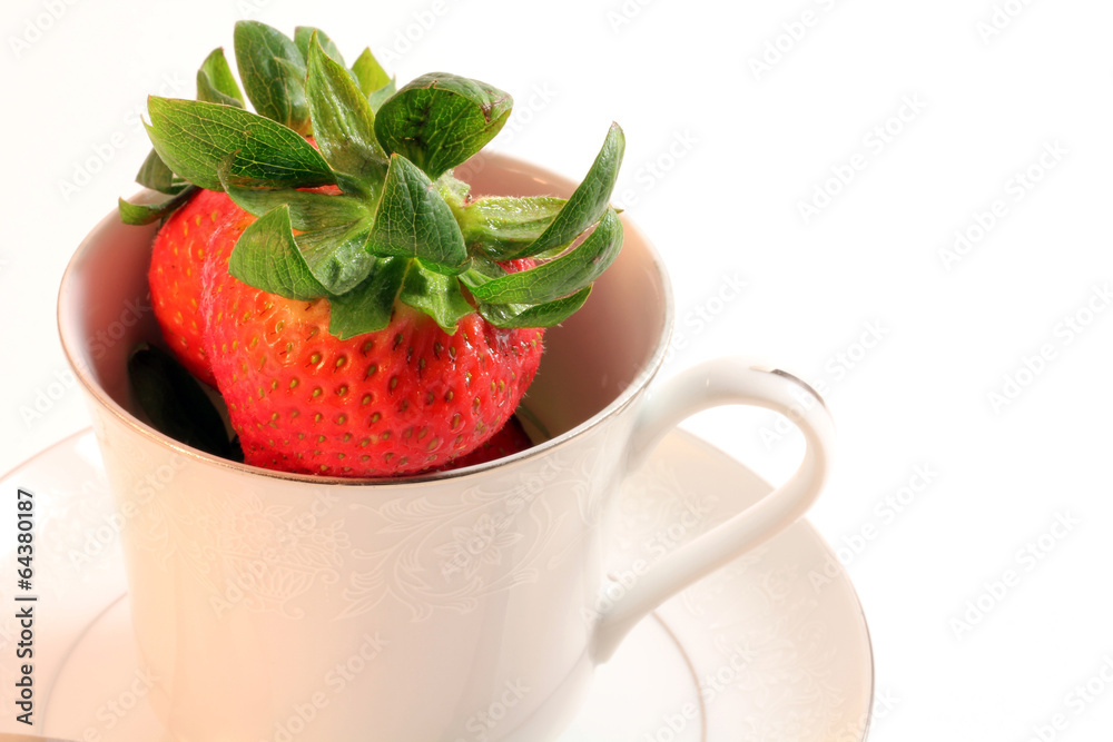 Fresh Red Strawberries in White China Teacup with Saucer on Plai Fresh Red Strawberries in White China Teacup with Saucer on Plai