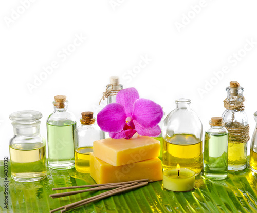 spa supplies with frangipani oil yellow candle on banana leaf