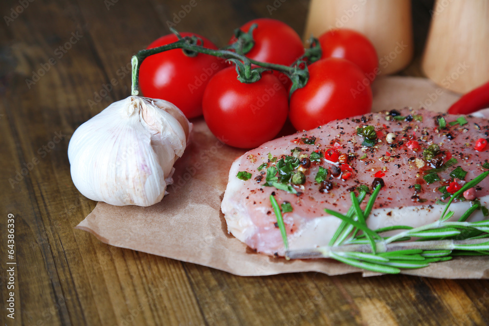 Raw meat steak with spices herbs, on wooden background Raw meat steak with spices herbs, on wooden background