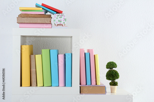 Books on white shelves in room