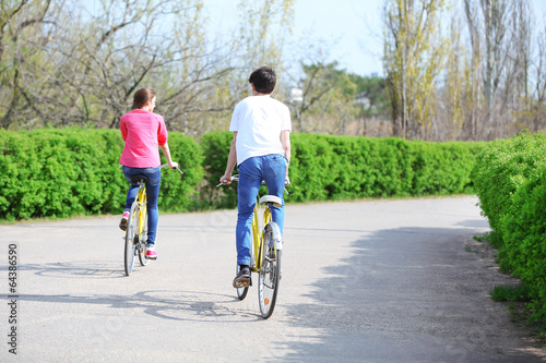 Wallpaper Mural Young couple riding on bicycles in park Torontodigital.ca