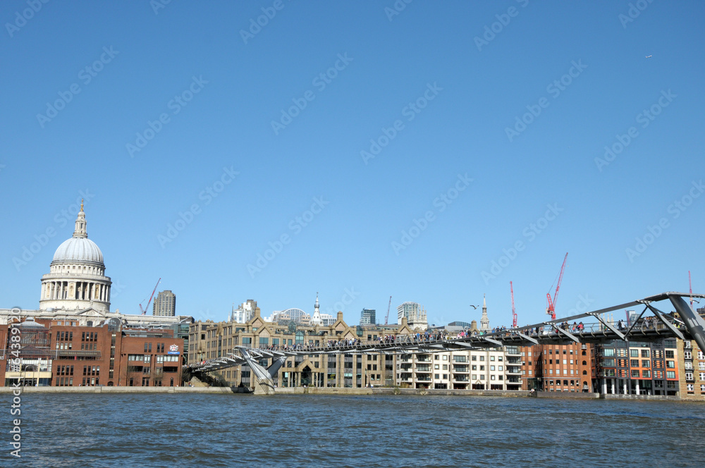 London skyline across River Thames at Millennium Bridge