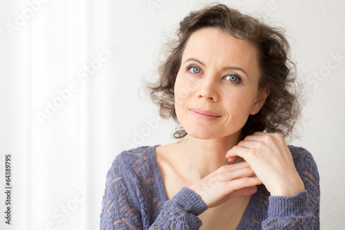 Romantic woman looking into camera with smile