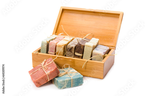 Handmade soaps in wooden box isolated on white background