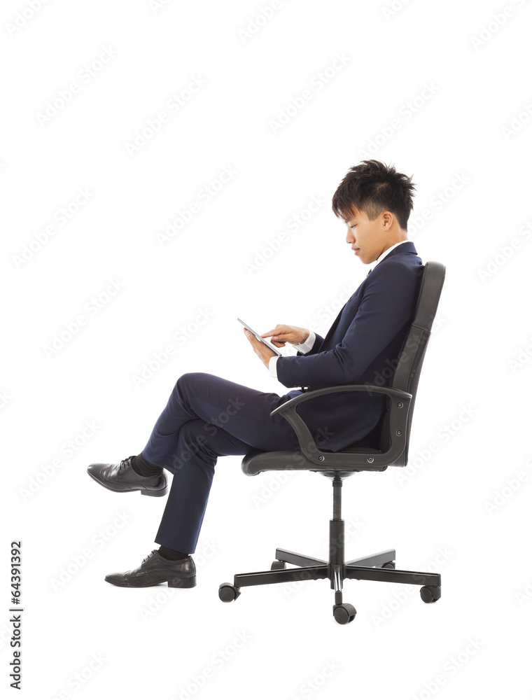 businessman using tablet pc on the chair businessman using tablet pc on the chair