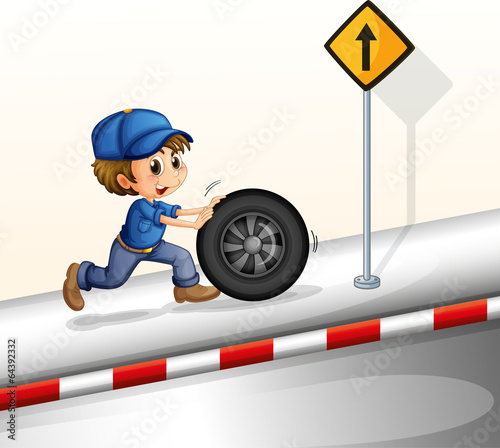 A smiling mechanic pushing the tire