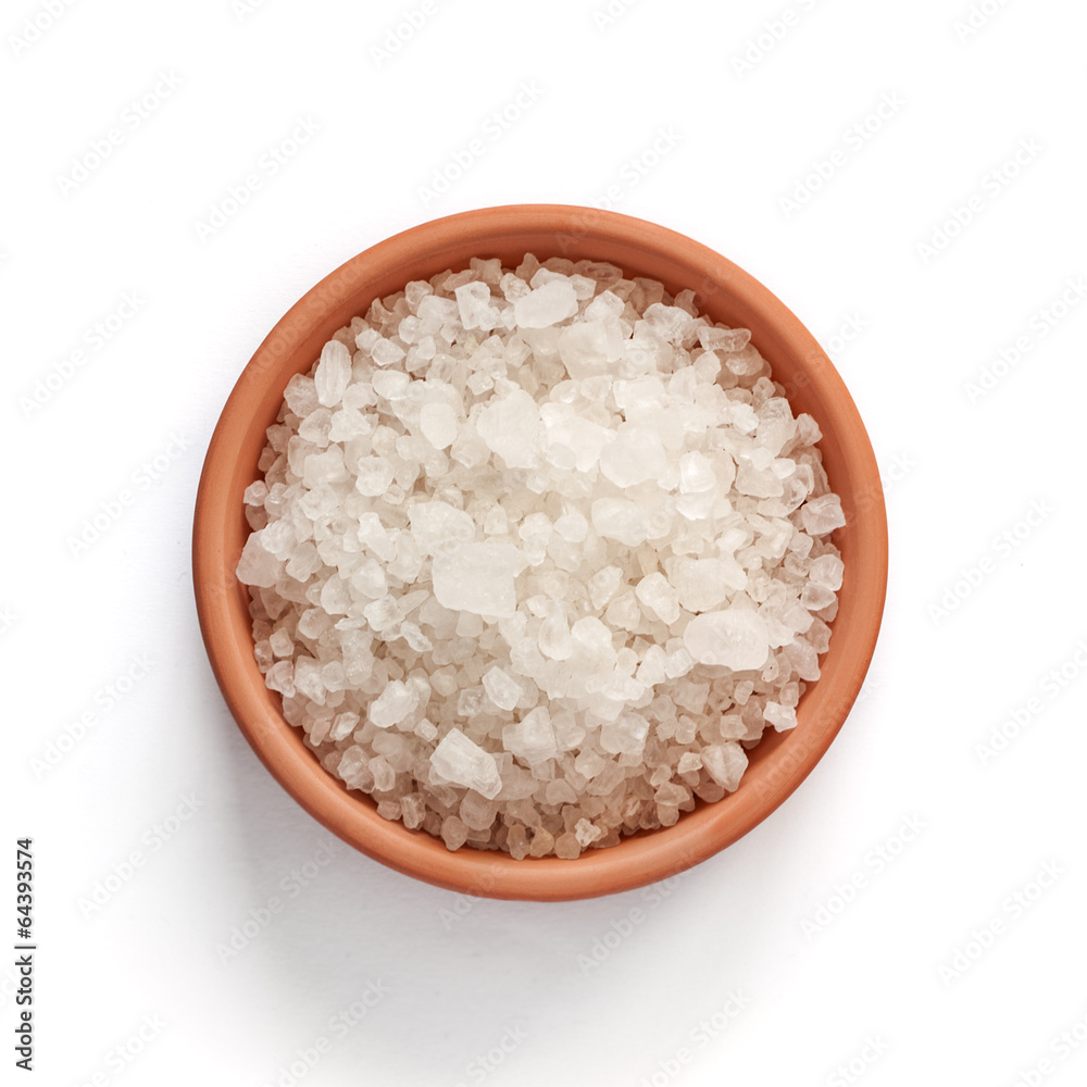 Sea salt in bowl on white background Sea salt in bowl on white background