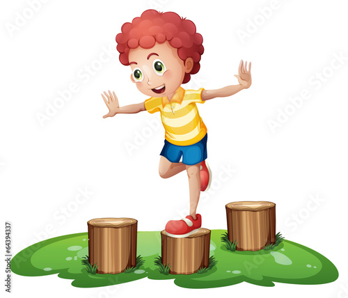 A cute young boy playing above the stumps