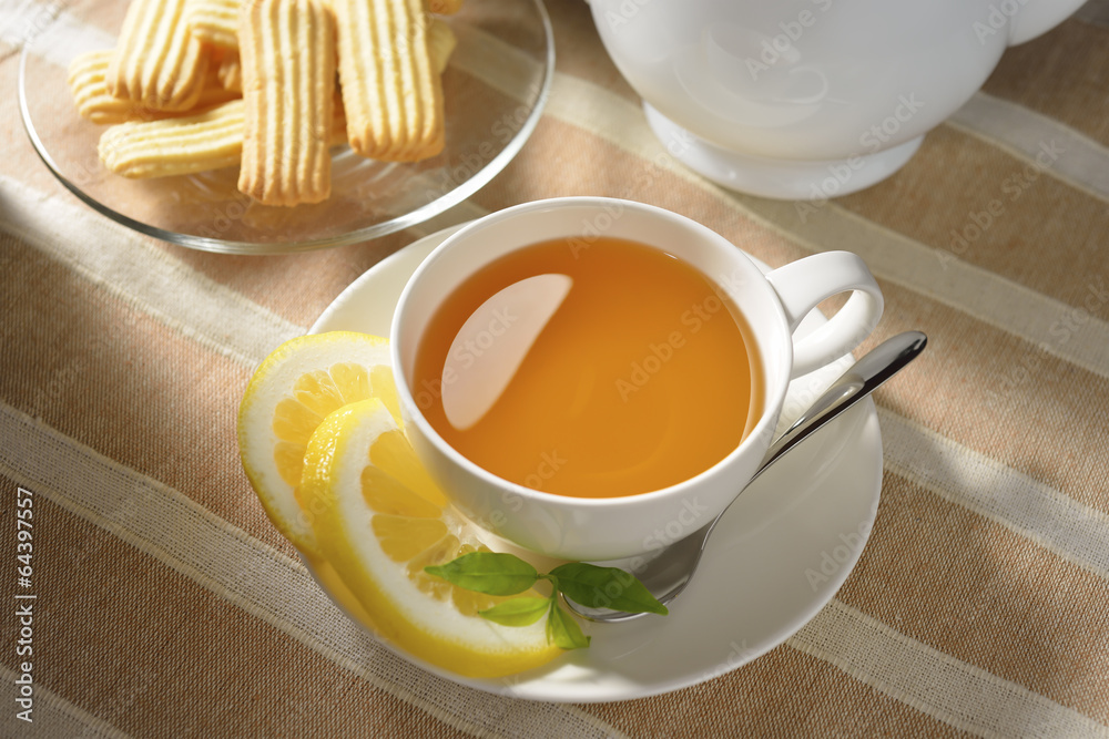 Cup of tea with lemon and cookies on table Cup of tea with lemon and cookies on table