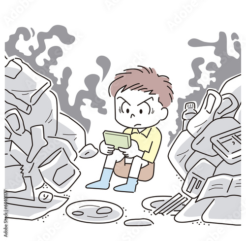 ゴミの中でゲームをする男の子