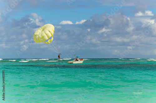 A parachute being towed at sea with a clear blue sky