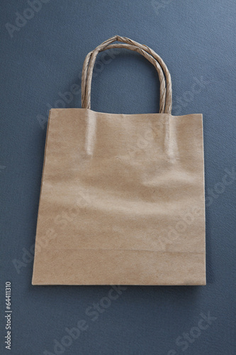 Recycled paper shopping bag on gray background