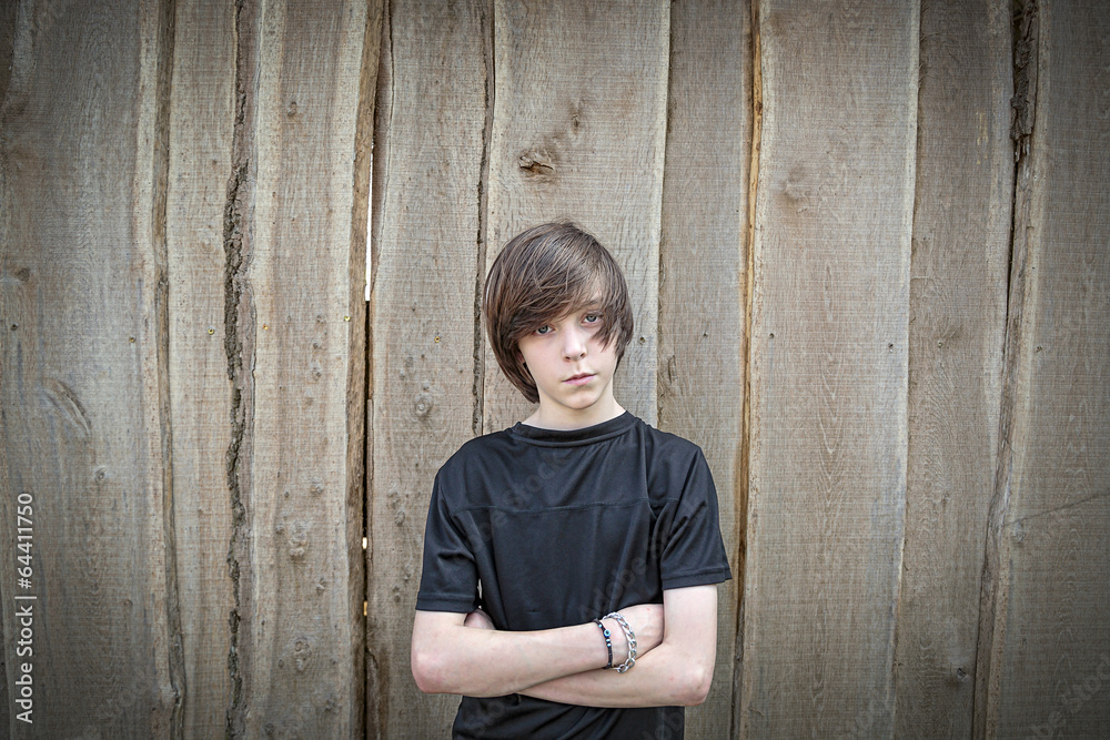 wide angel portrait of a teenage boy in front of a wooden wall wide angel portrait of a teenage boy in front of a wooden wall