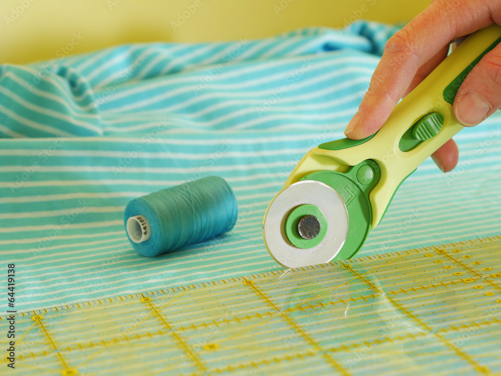 close up of cutting fabric with rotary cutter Stock Photo | Adobe Stock