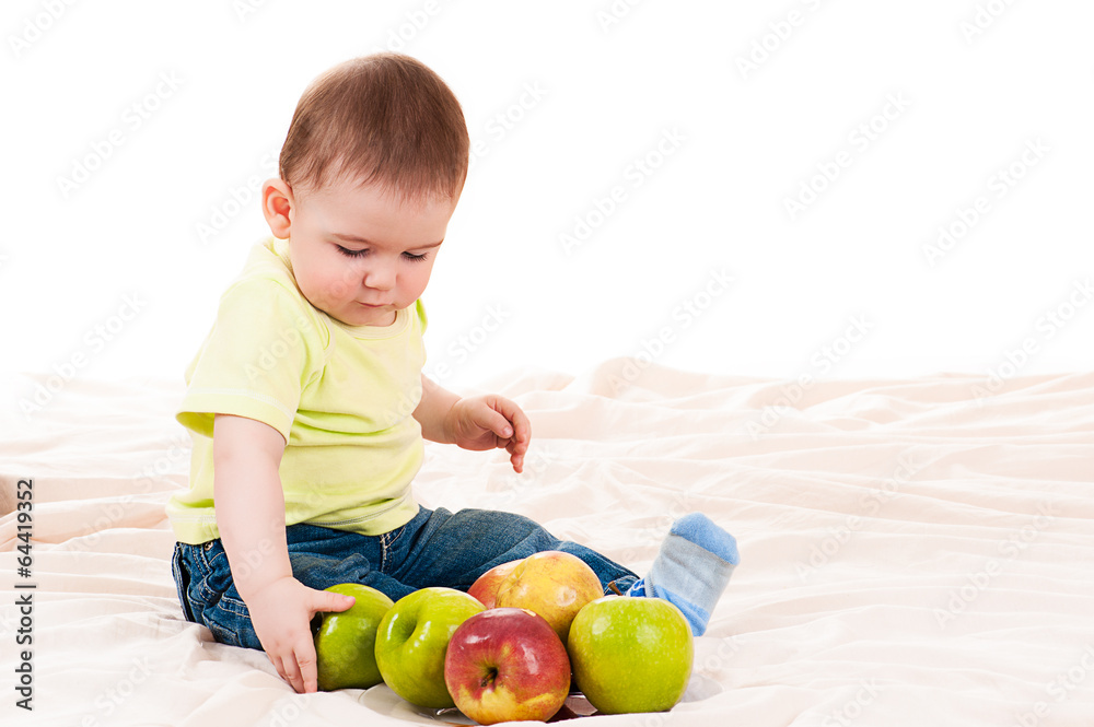 Fototapeta premium little baby playing with apples