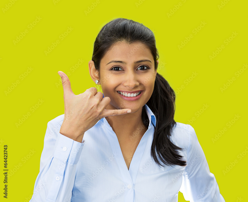 Young businesswoman giving call me gesture, green background Young businesswoman giving call me gesture, green background