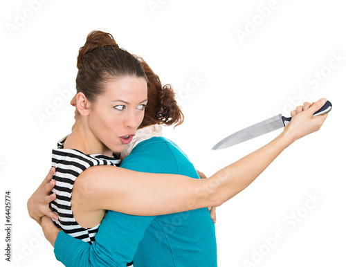 Sneaky woman hugging lady at same time trying to stab her 